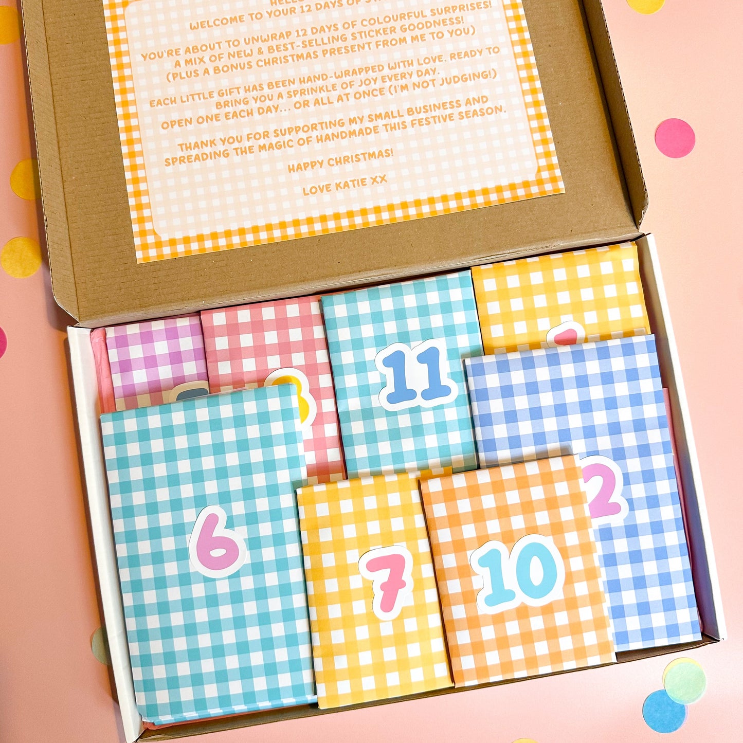 Box of colorful sticker advent calendar with numbers on a pink background