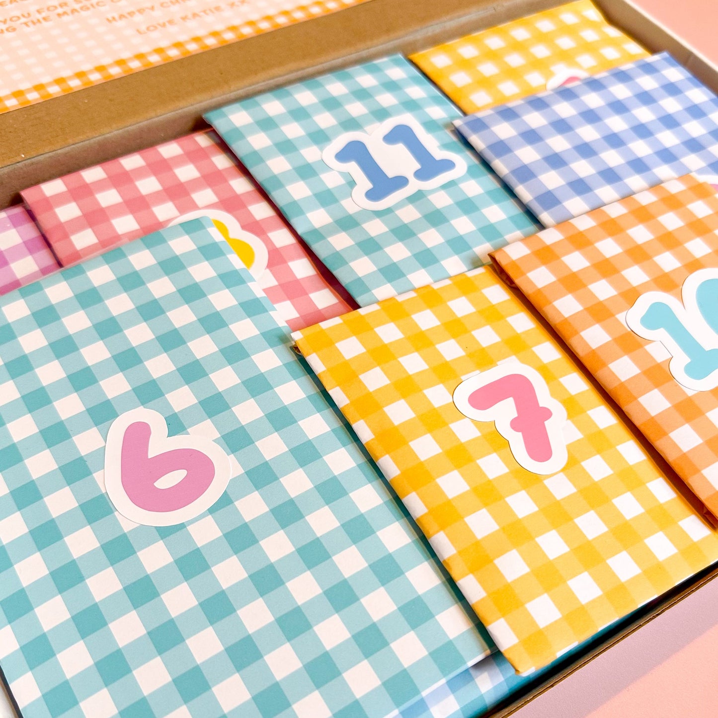 Colorful checkered cards with numbers on a pink background
