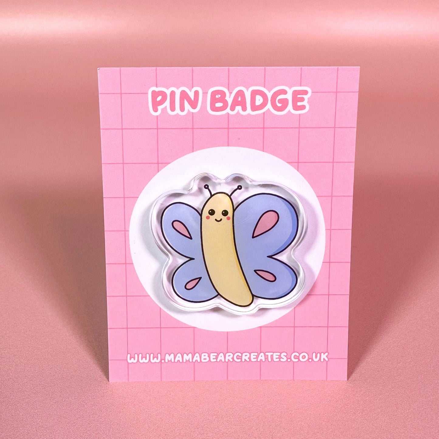 Pin badge with butterfly design on a pink card with 'Mama Bear Creates' branding.