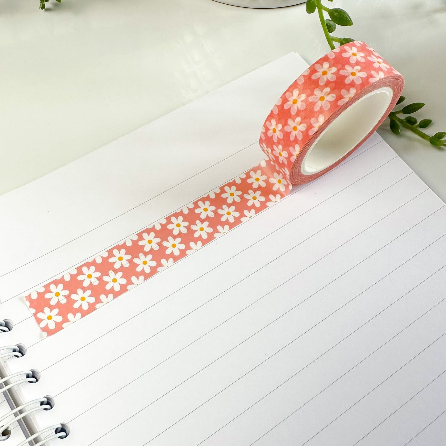 pink daisy washi tape on notebook