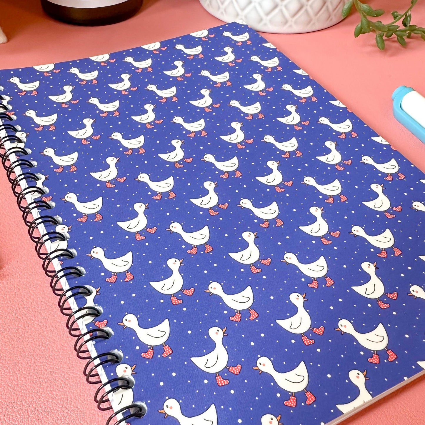 Notebook with duck pattern on a pink surface