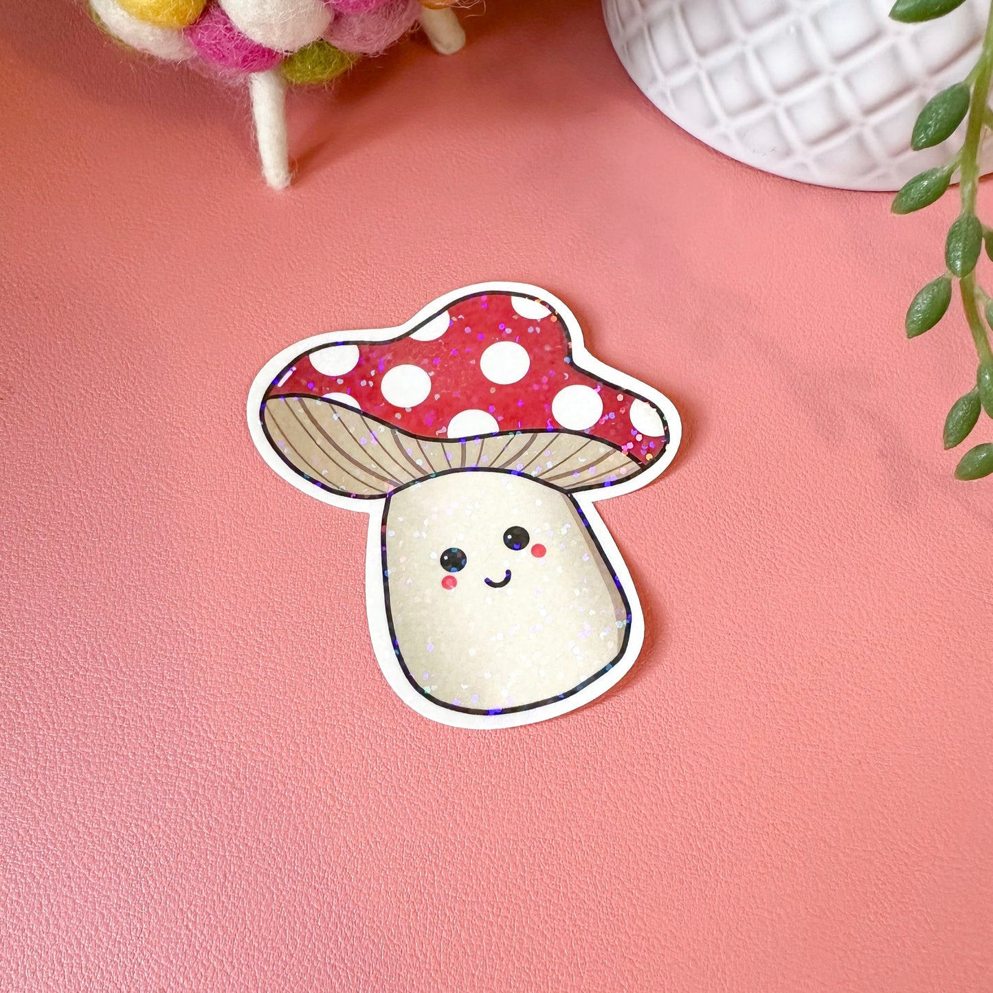 Sticker of a cute mushroom with a polka dot cap on a pink background