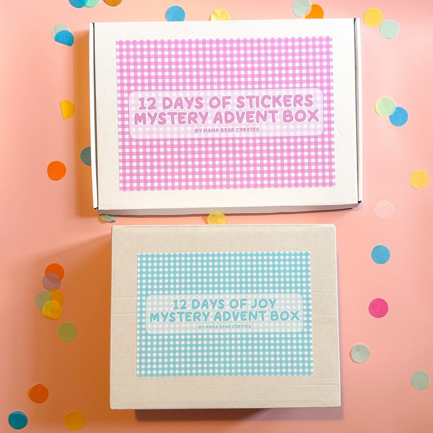 Two mystery advent boxes with colorful confetti on a pink background