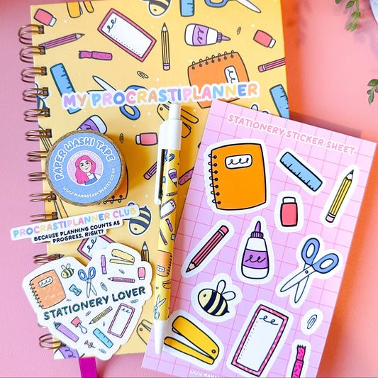 Notebook with stationery-themed stickers and a pink background