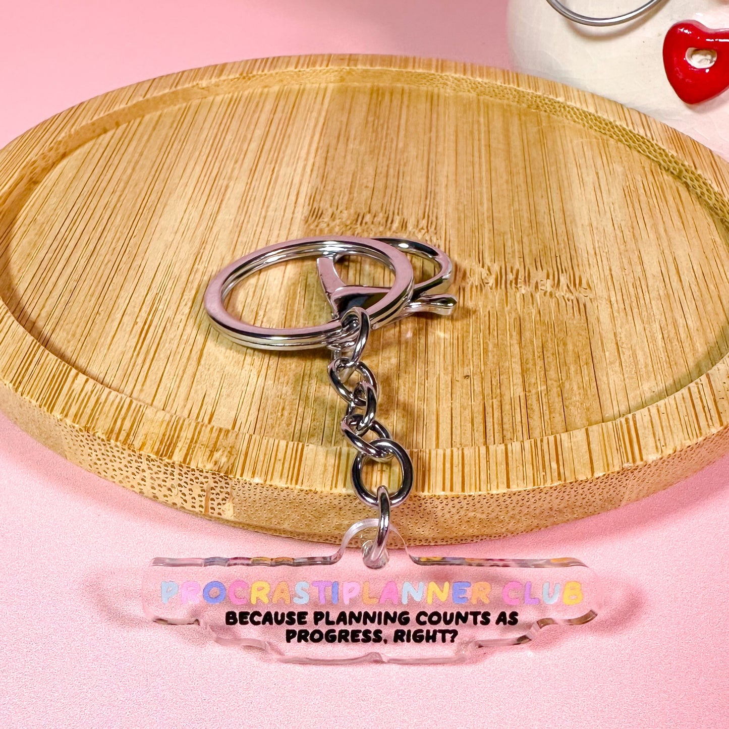 Keychain with a clear tag on a pink background