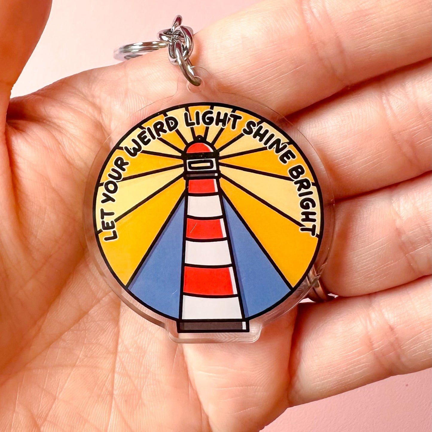 weird light lighthouse keyring on hand