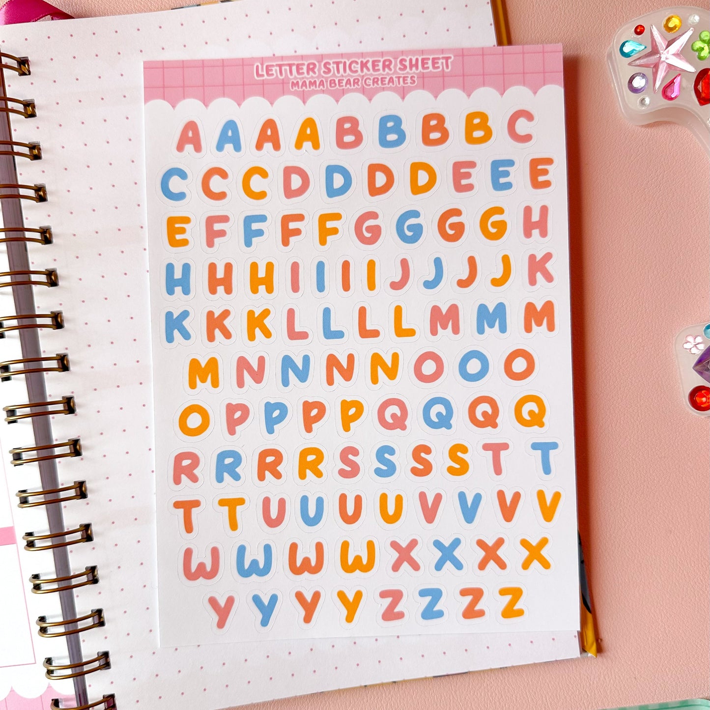 PLANNER ON PINK DESK WITH LETTER STICKER SHEET