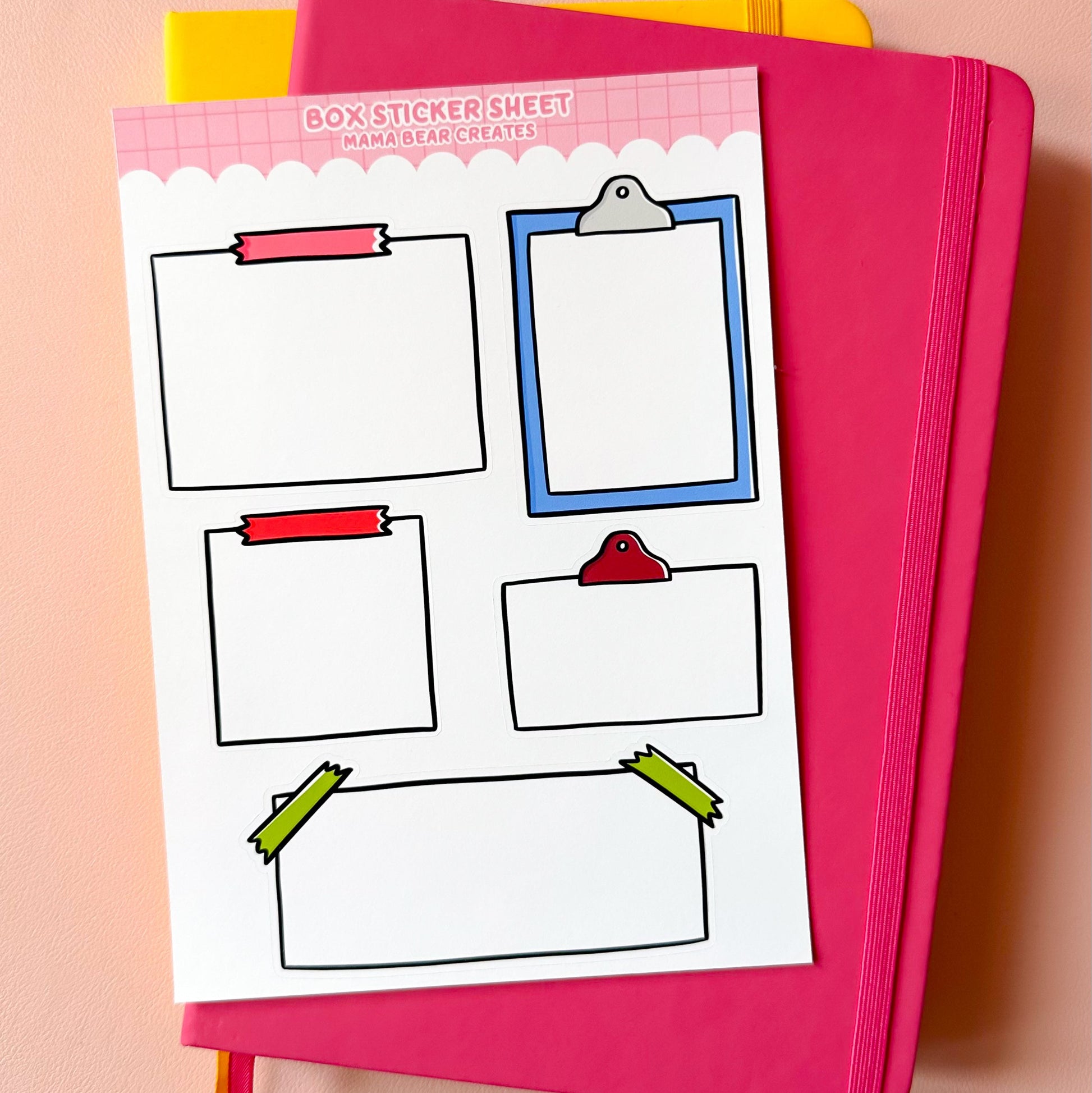 Pink notebook with a sheet of clipart on a pink background