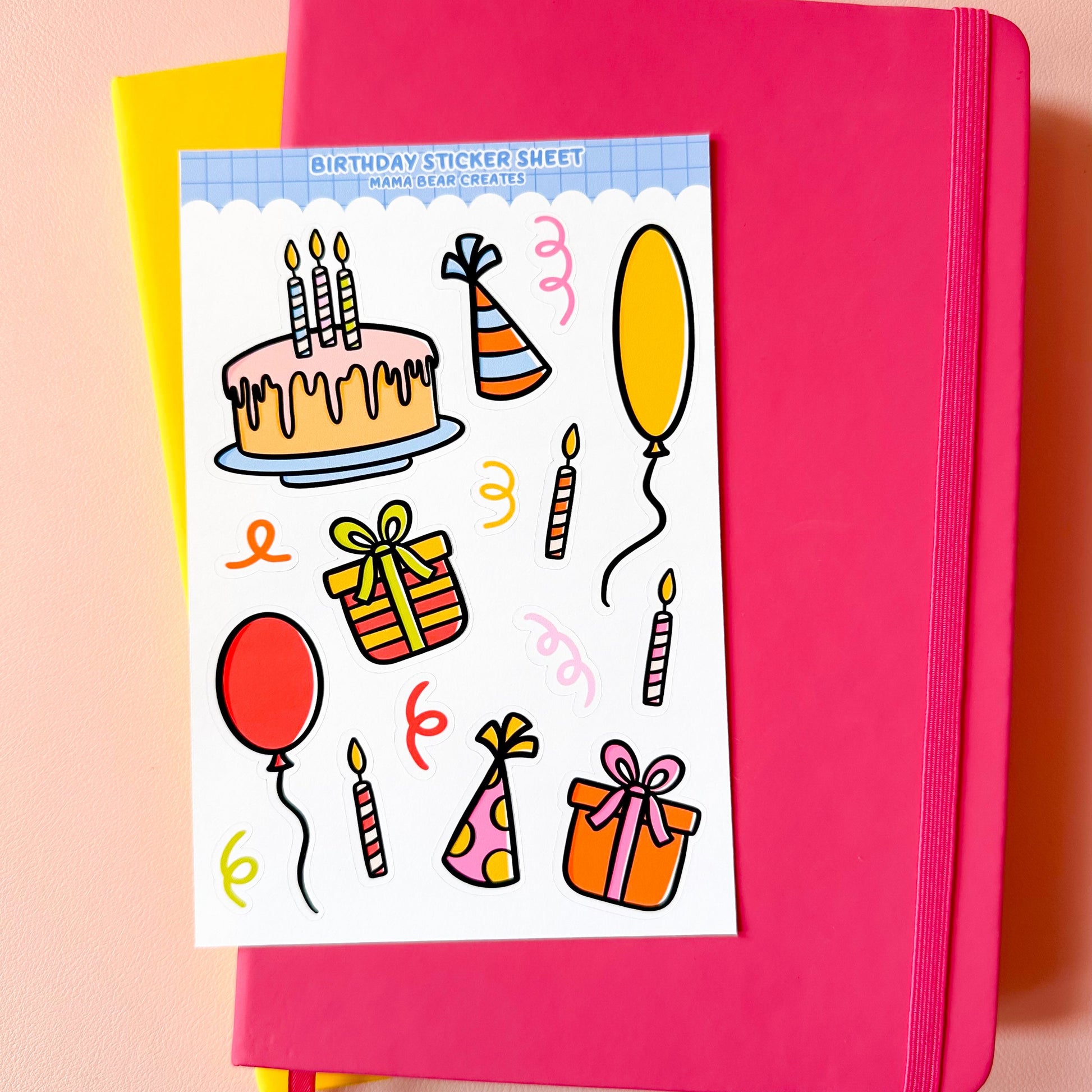 Pink notebook with a birthday-themed sticker sheet on a pink background