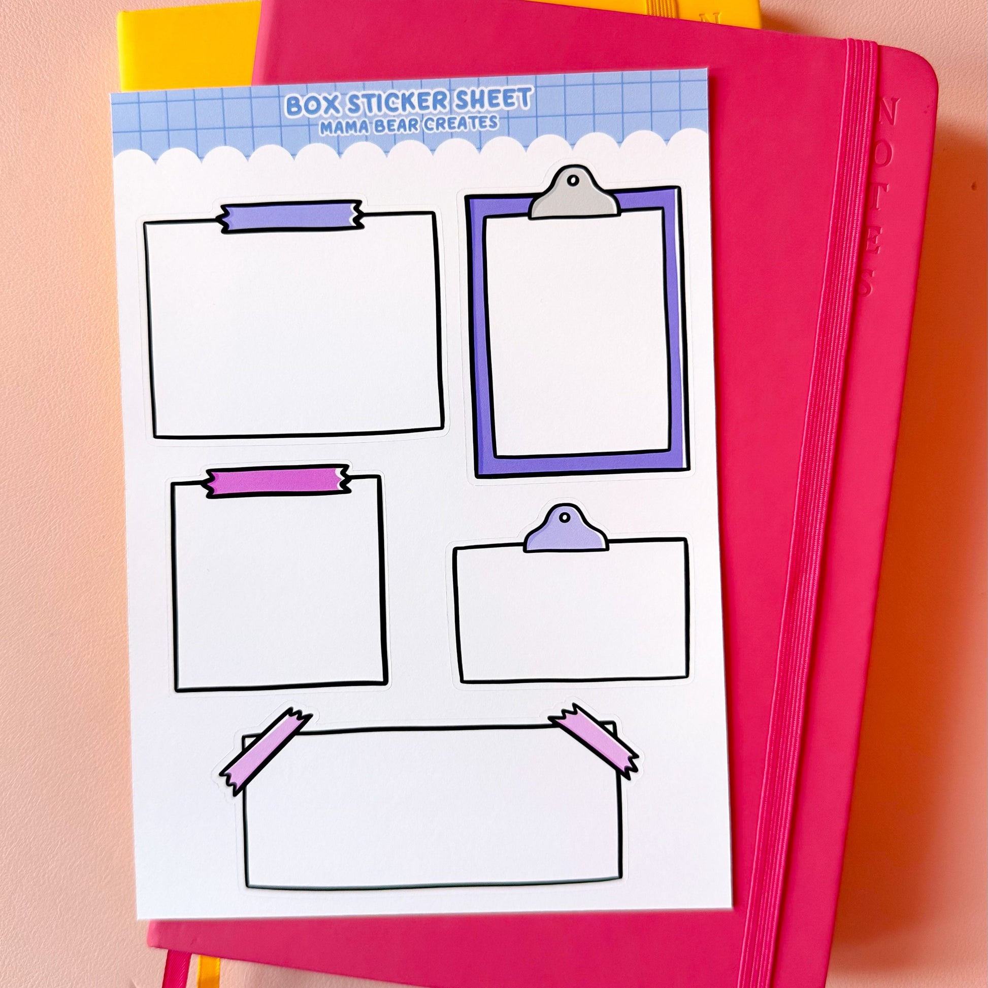 Pink notebook with a sticker sheet featuring various design elements on a peach background
