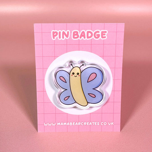 Pin badge with butterfly design on a pink card with 'Mama Bear Creates' branding.