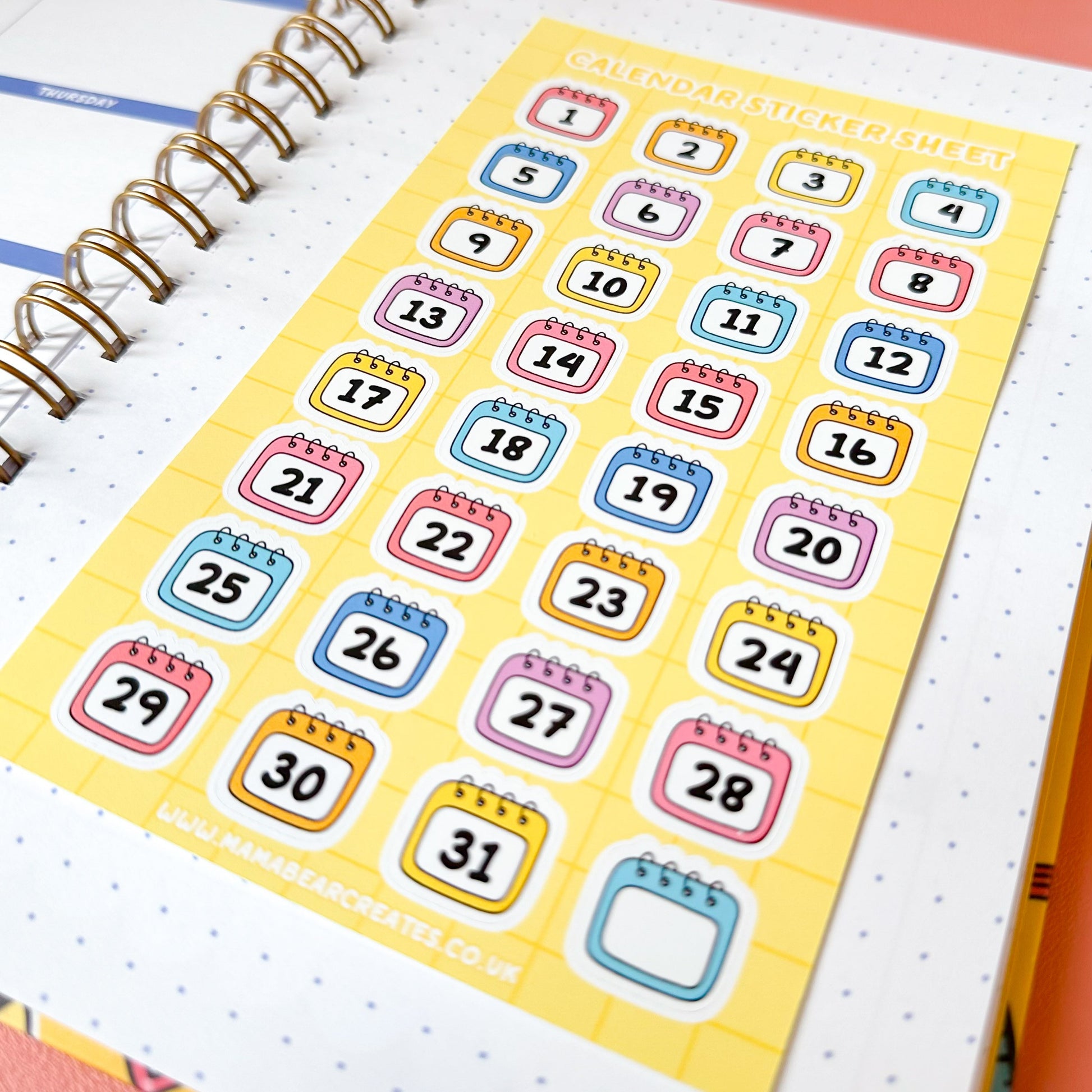Calendar stickers on a planner with a colorful background