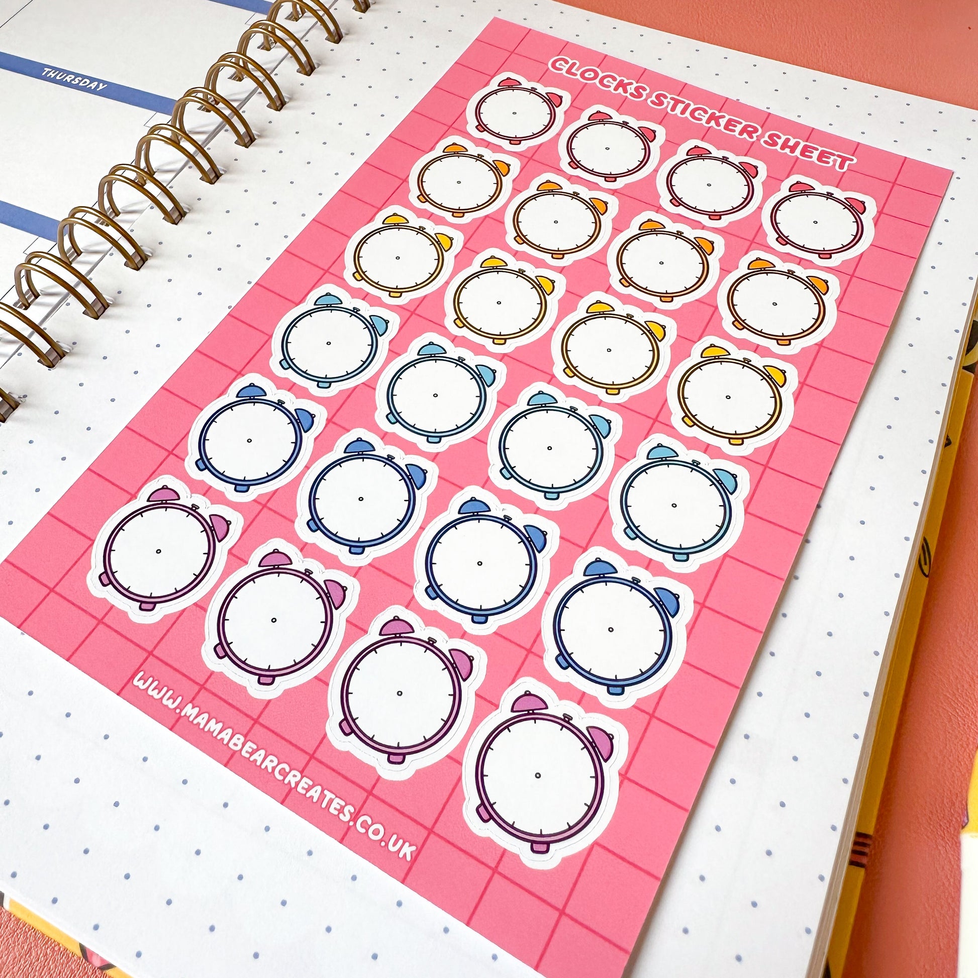 Sheet of decorative stickers with bear designs on a pink background, placed on a planner.