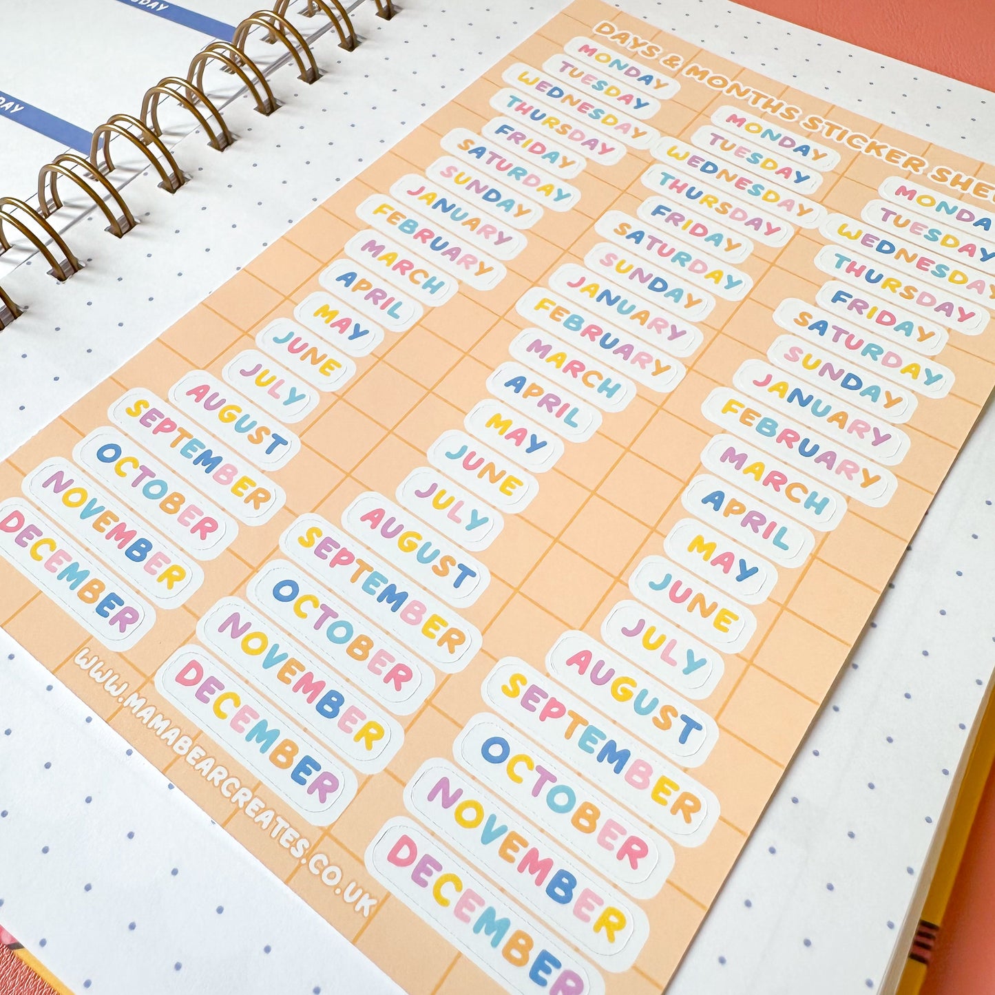Sheet of colorful month labels on a planner with a visible brand name.