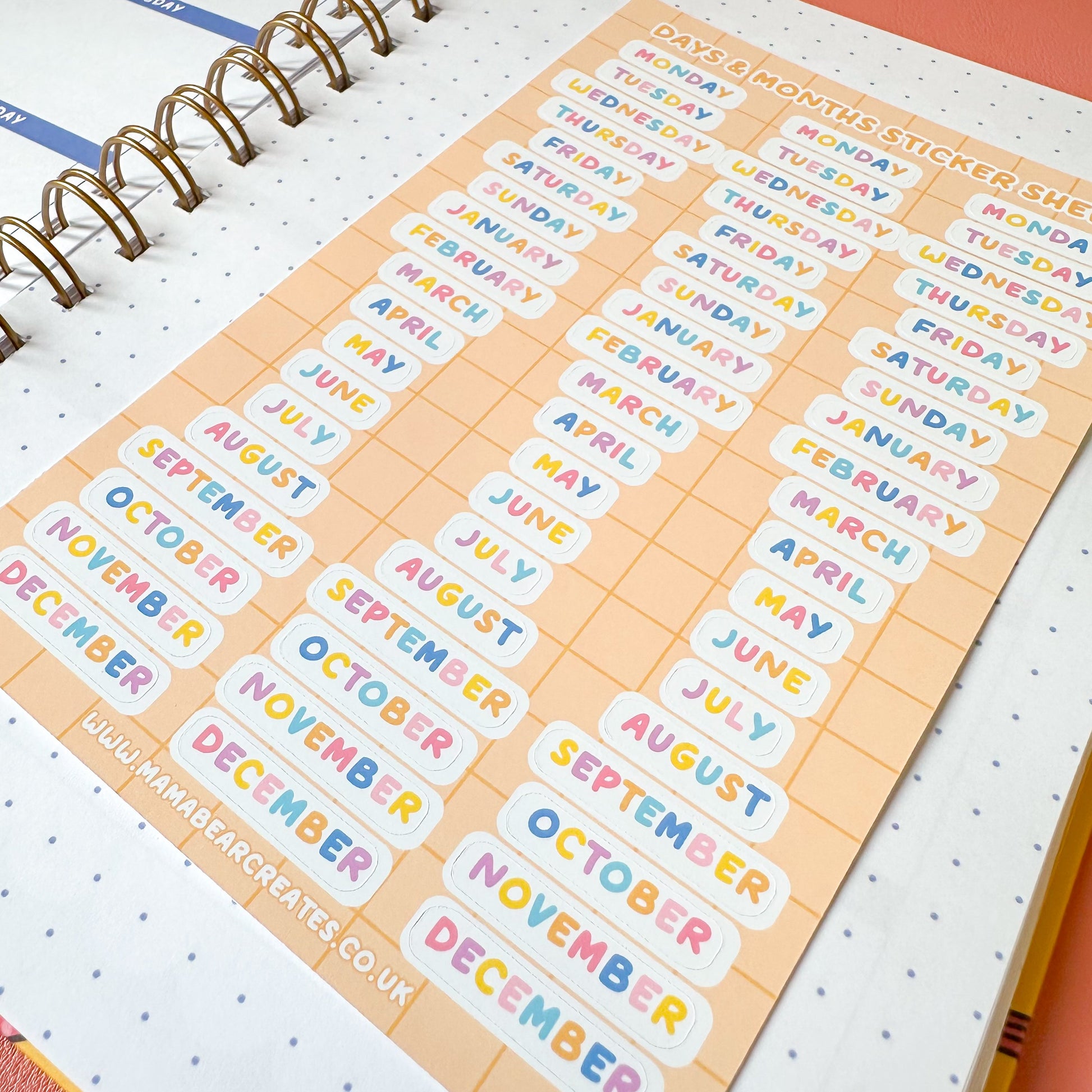 Sheet of colorful month labels on a planner with a visible brand name.