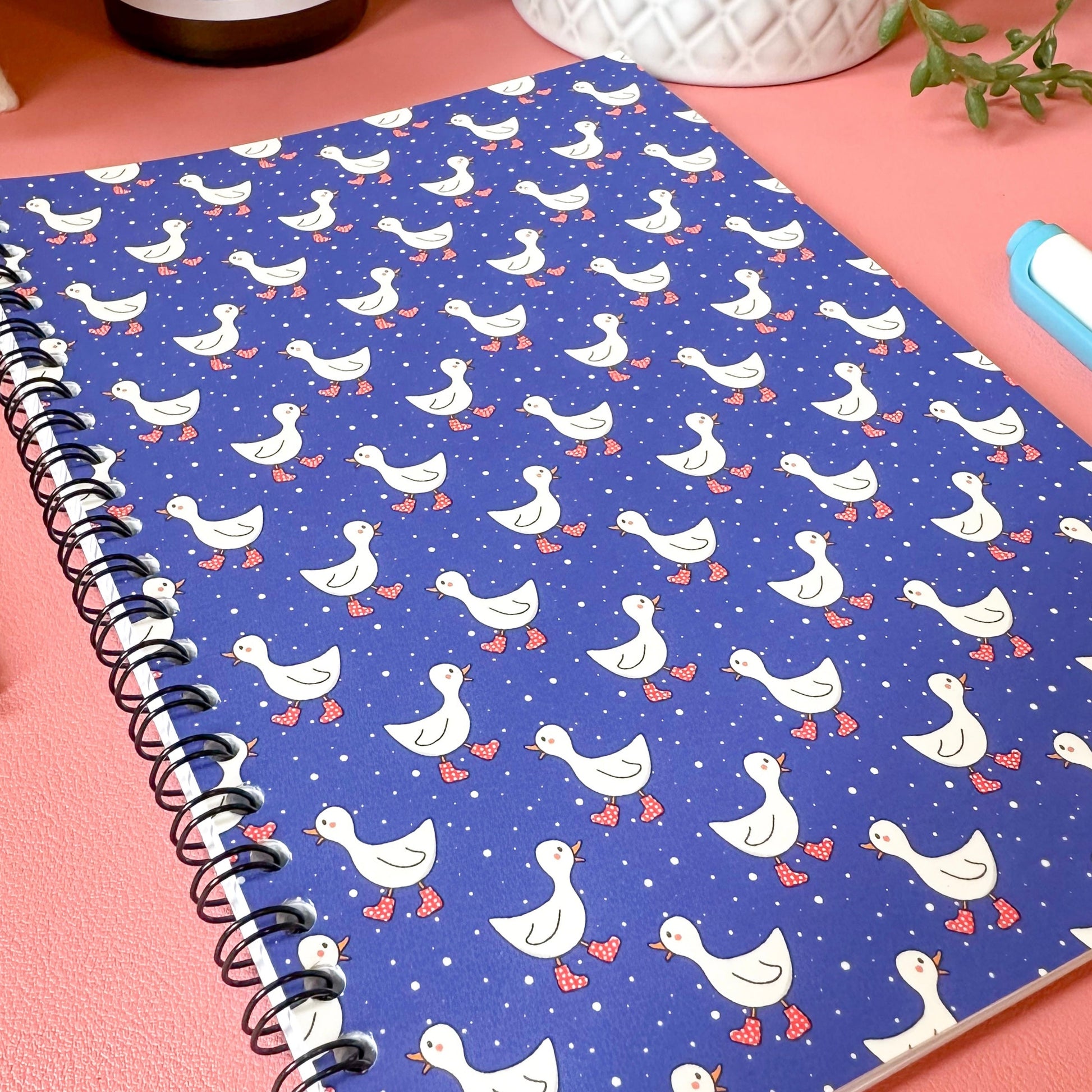 Notebook with duck pattern on a pink surface