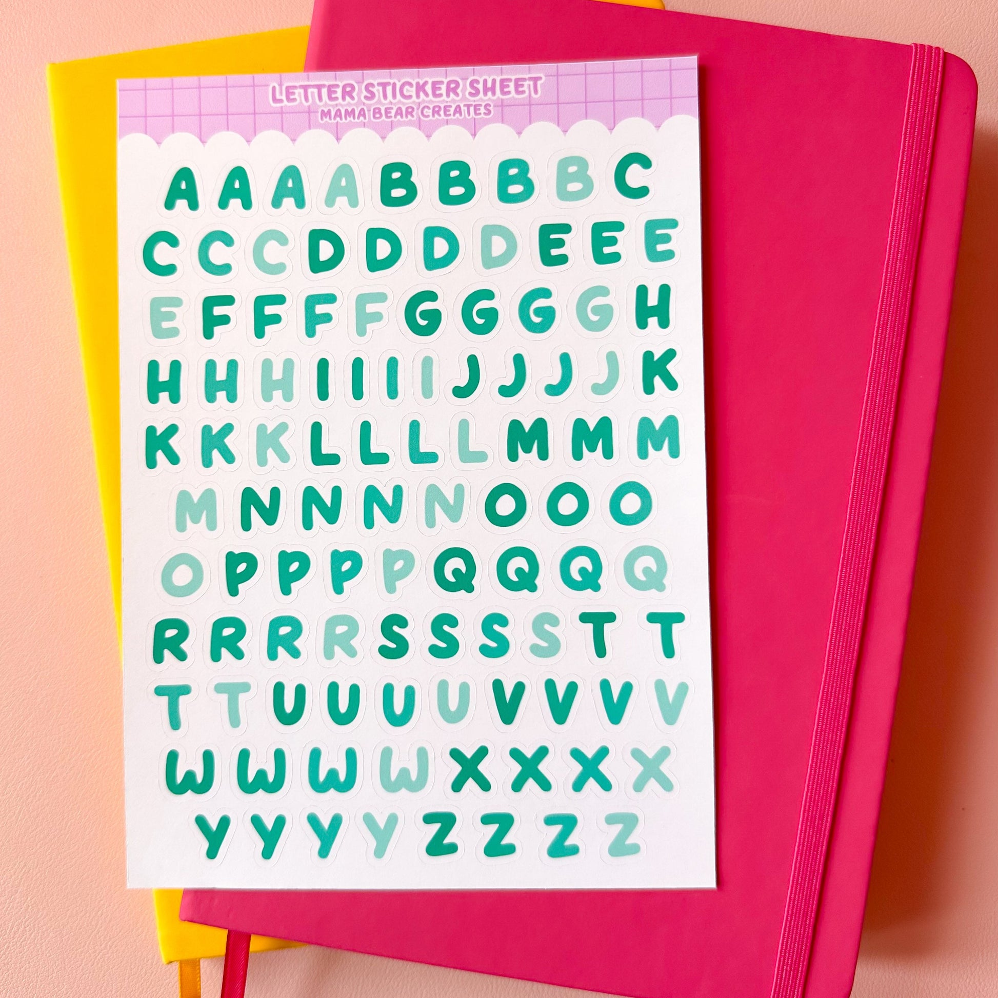 Sheet of letter-sized alphabet stickers with a pink border on a pink background