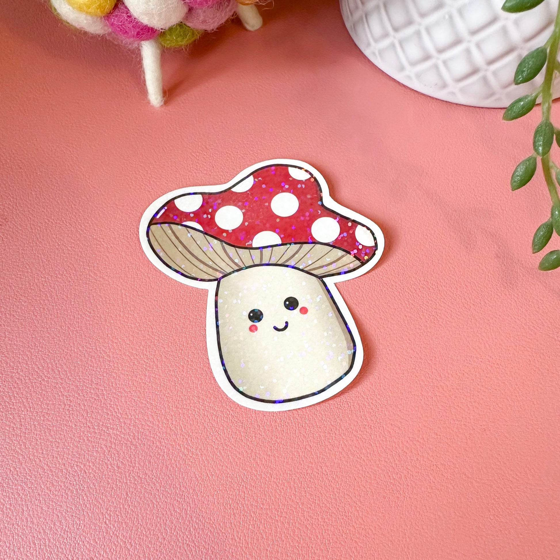 Sticker of a cute mushroom with a polka dot cap on a pink background
