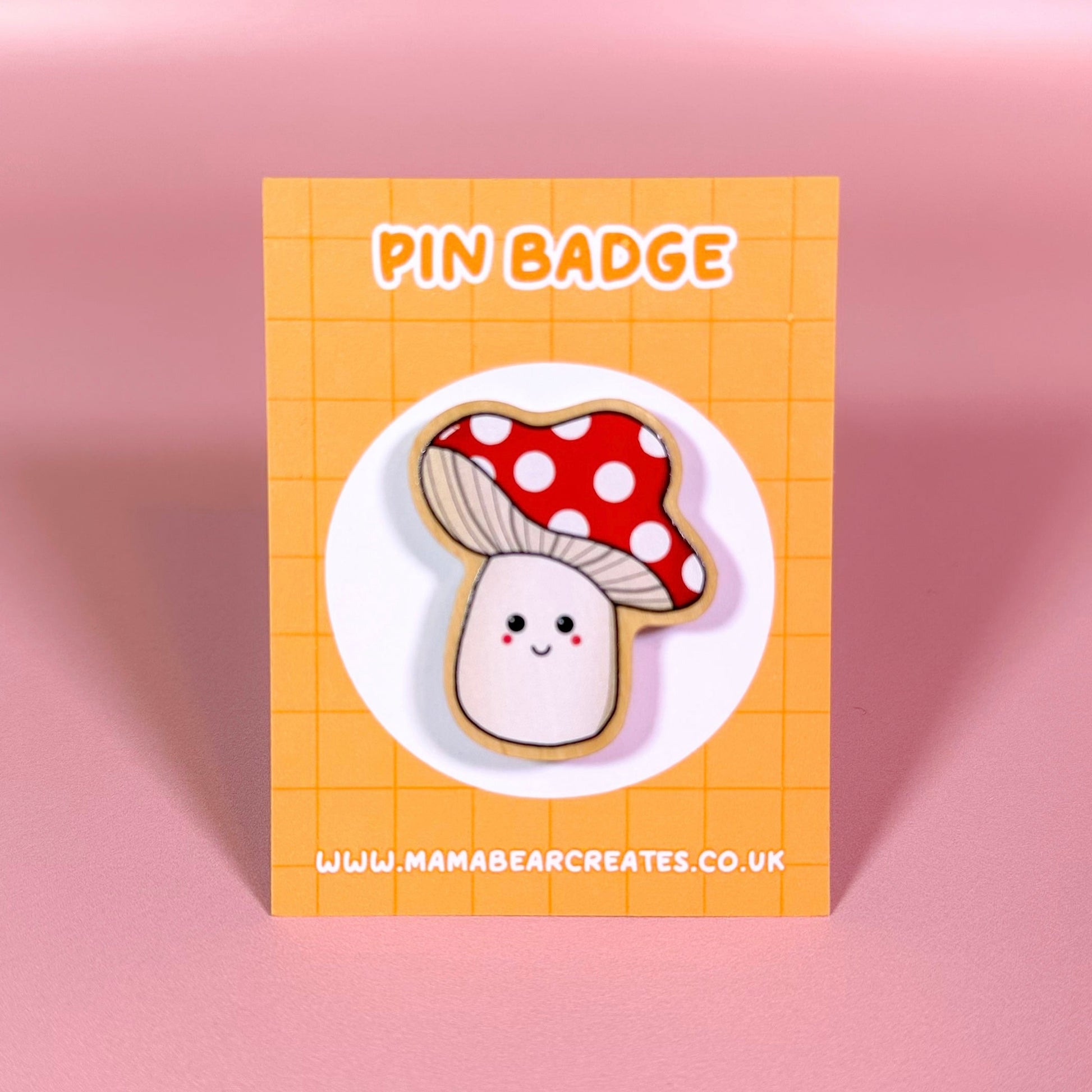 Pin badge with a cute mushroom design on a orange card with 'Mama Bear Creates' branding.