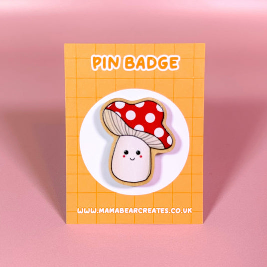 Pin badge with a cute mushroom design on a orange card with 'Mama Bear Creates' branding.