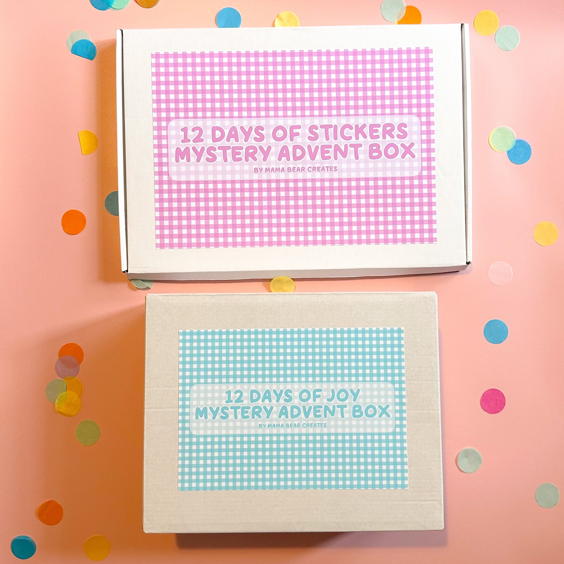 Two mystery advent boxes with colorful confetti on a pink background