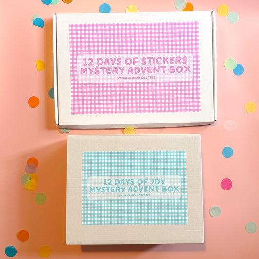 Two mystery advent boxes with colorful confetti on a pink background
