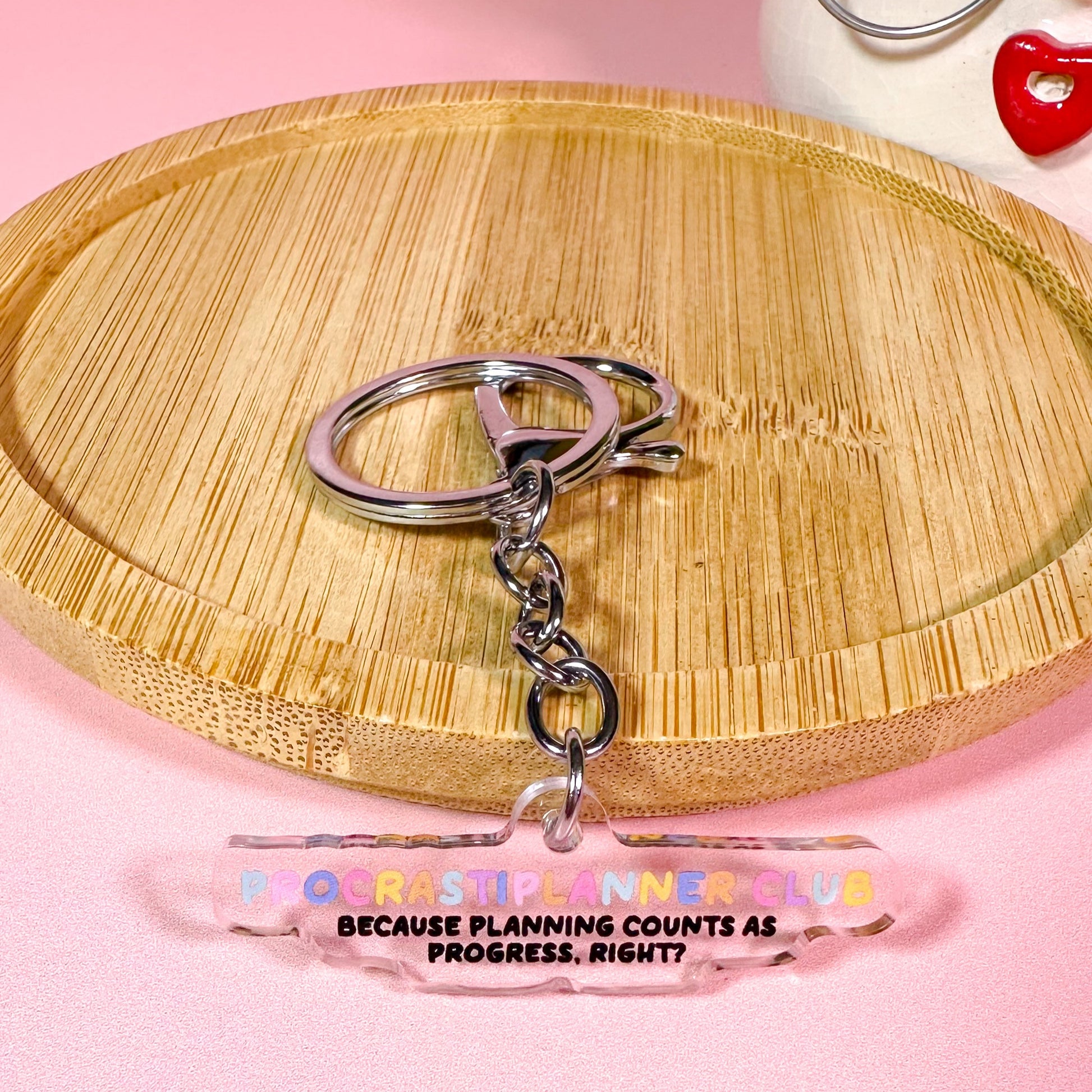 Keychain with a clear tag on a pink background