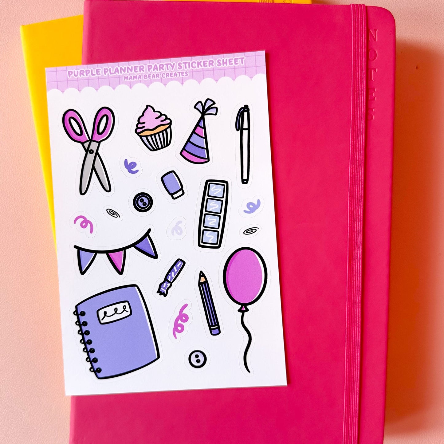 Pink notebook with a sticker sheet featuring party-themed stickers on a pink background