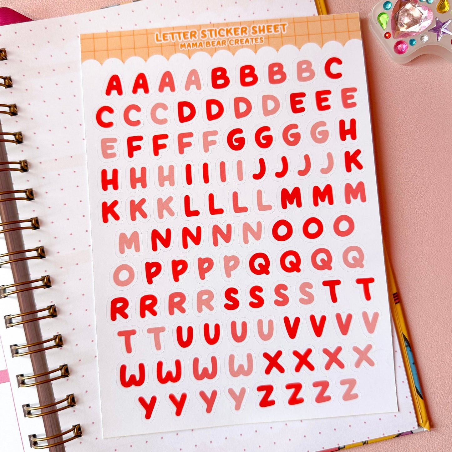 Letter sticker sheet with red letters on a notebook page