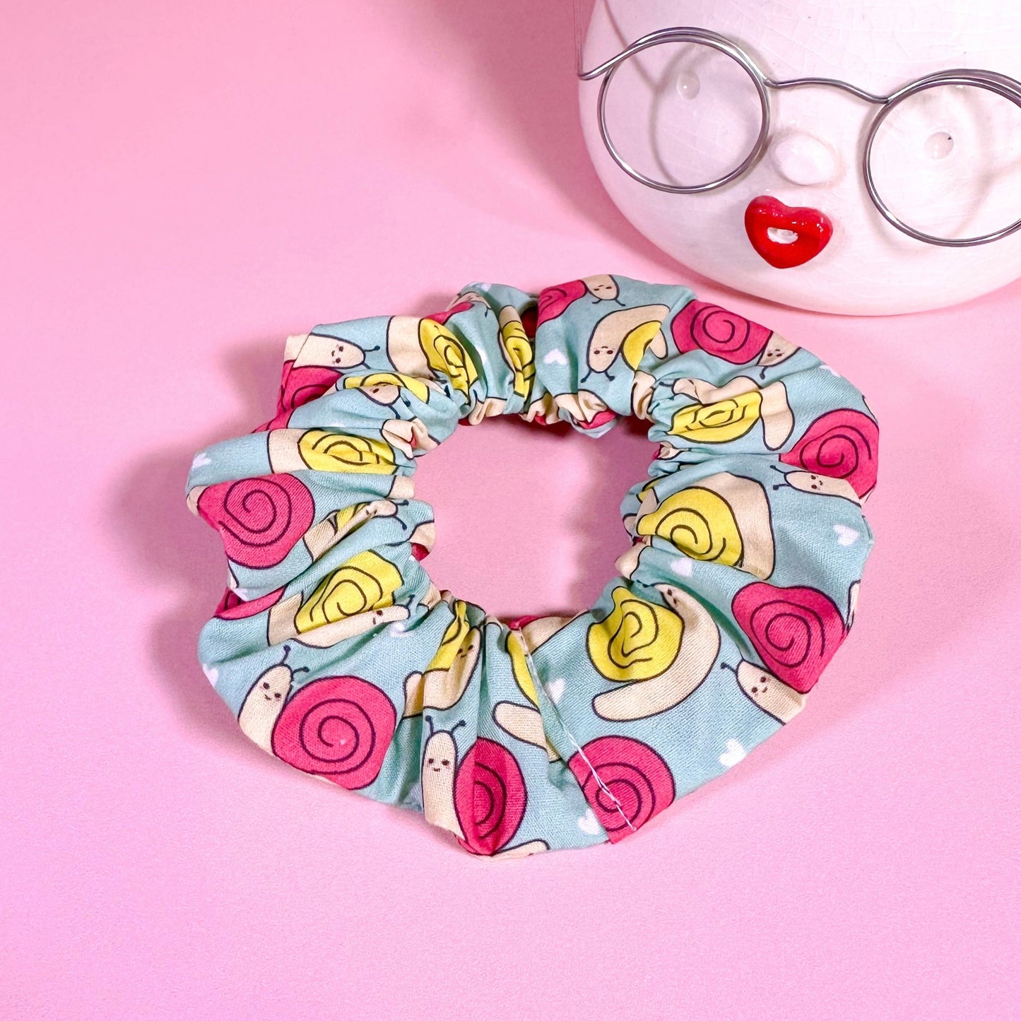 Scrunchie with colorful pattern on a pink background