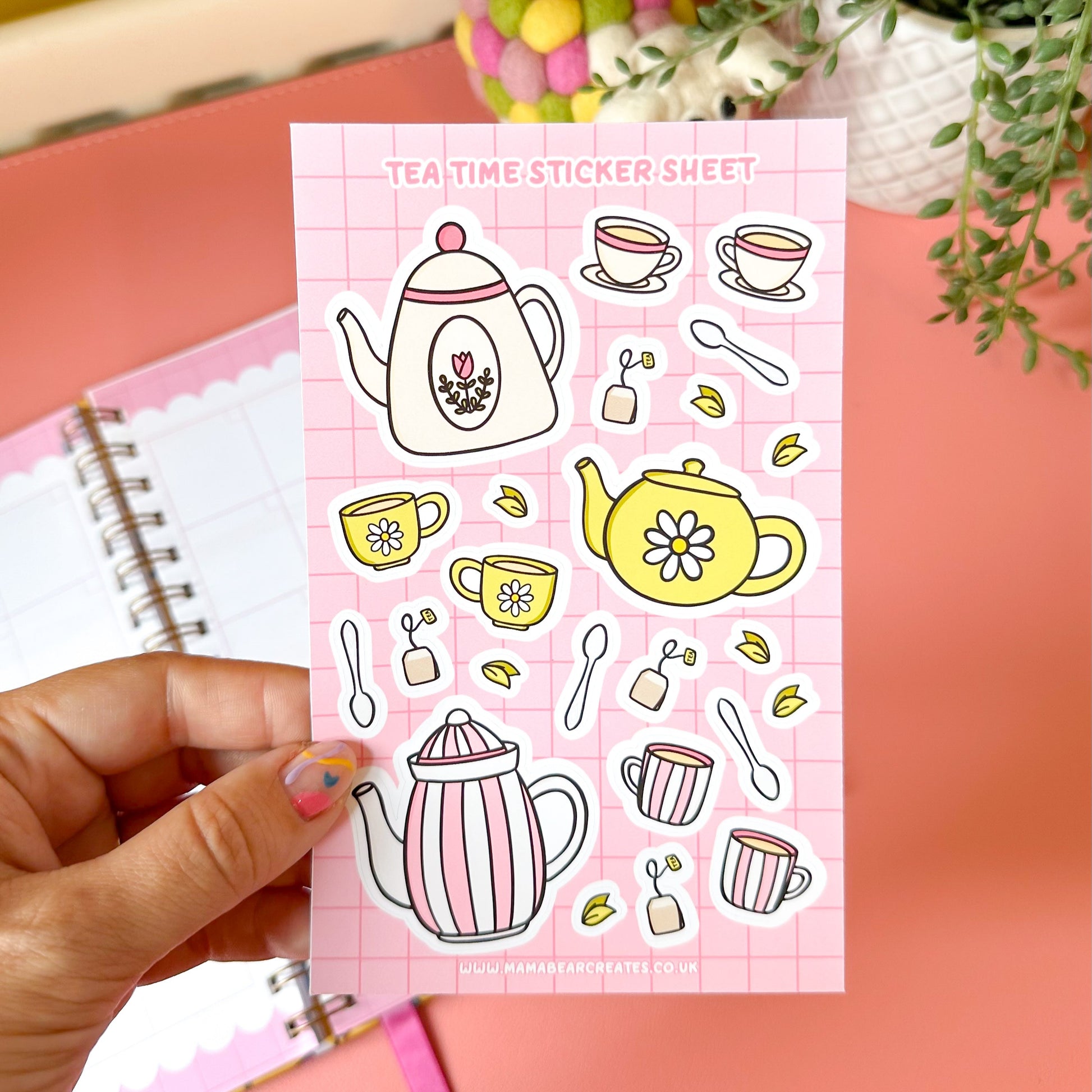Tea-themed sticker sheet held by a hand with a pink background