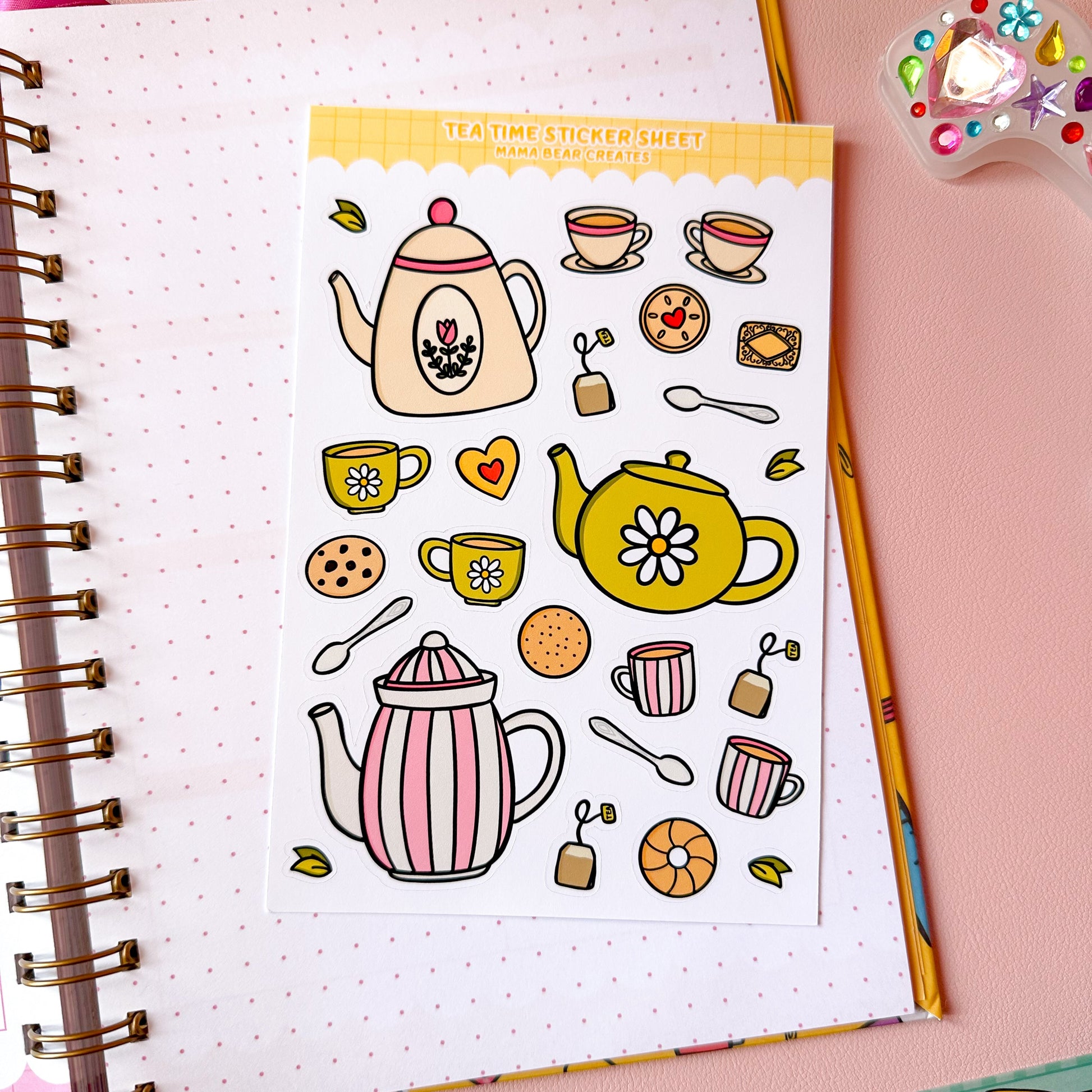 Sticker sheet with tea-themed designs on a notebook page with stationery items.