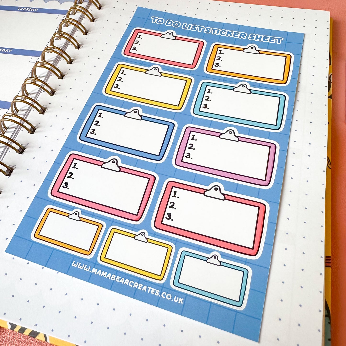 Sticker sheet with colorful labels on a spiral-bound notebook