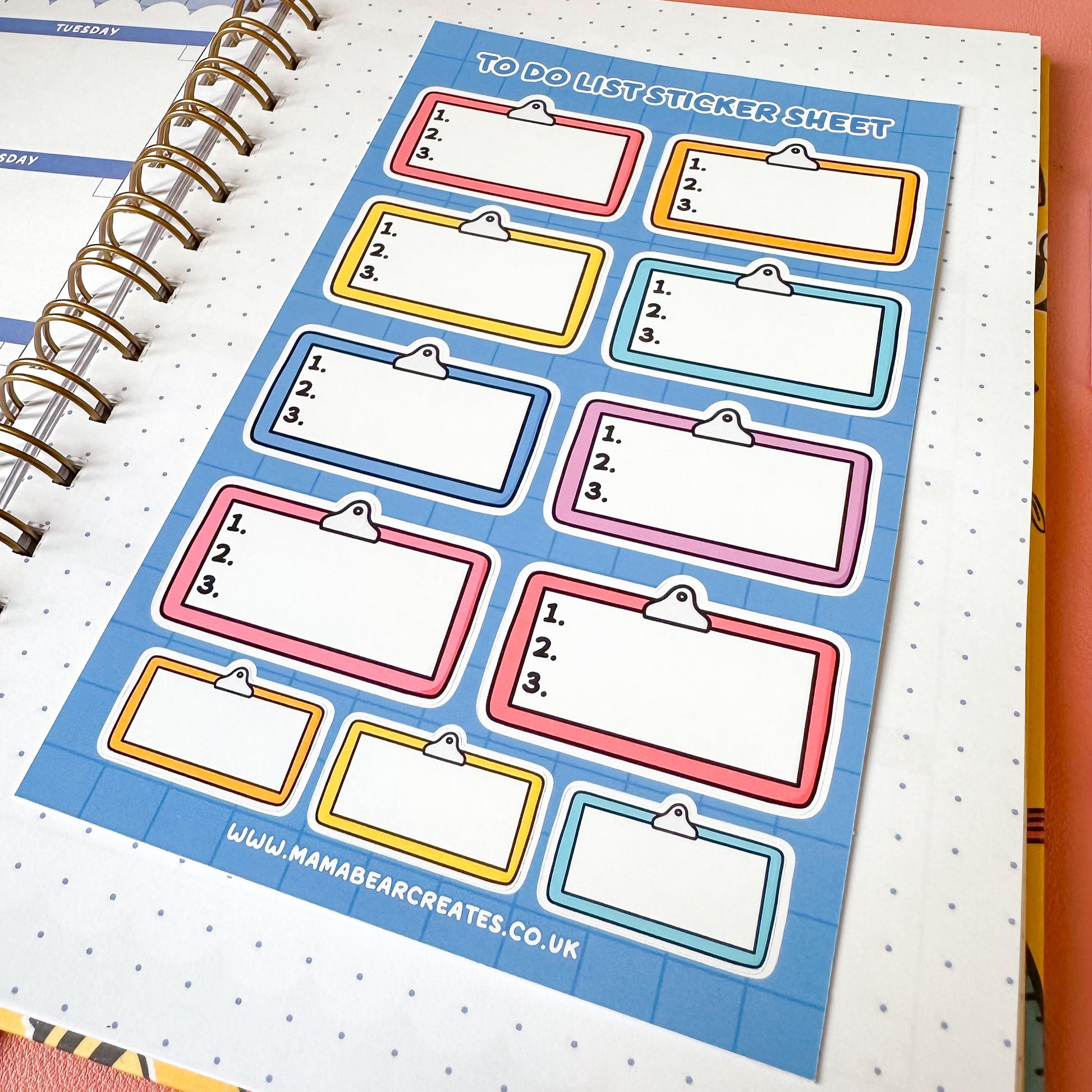 Sticker sheet with colorful labels on a spiral-bound notebook