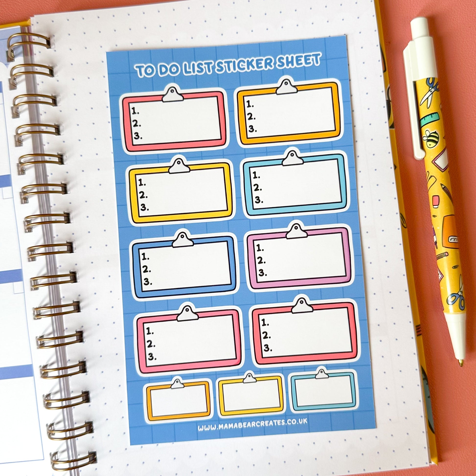 Sheet of colorful 'To Do List' stickers on a notebook with a pen on a pink background