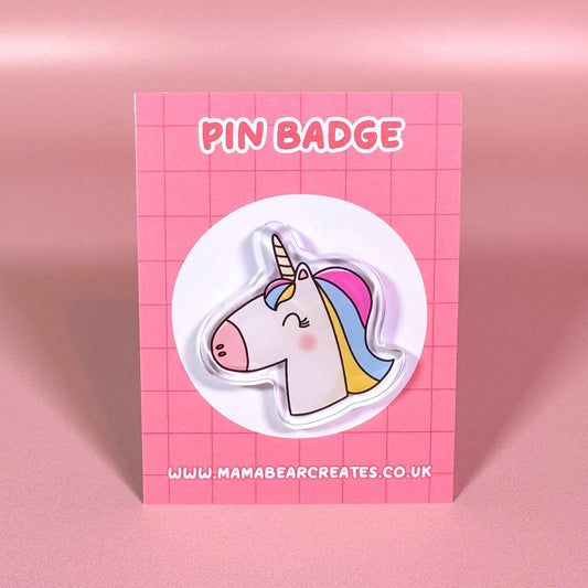 Pin badge of a unicorn on a pink card with 'Mama Bear Creates' branding.